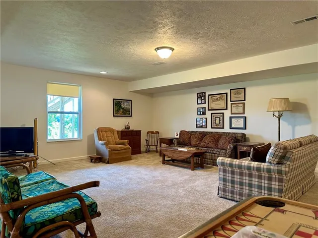 a living room with furniture window and a flat screen tv