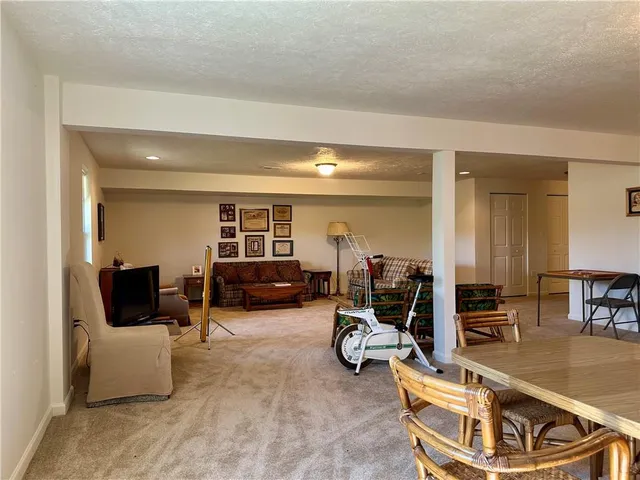 a living room with furniture and a gym machine