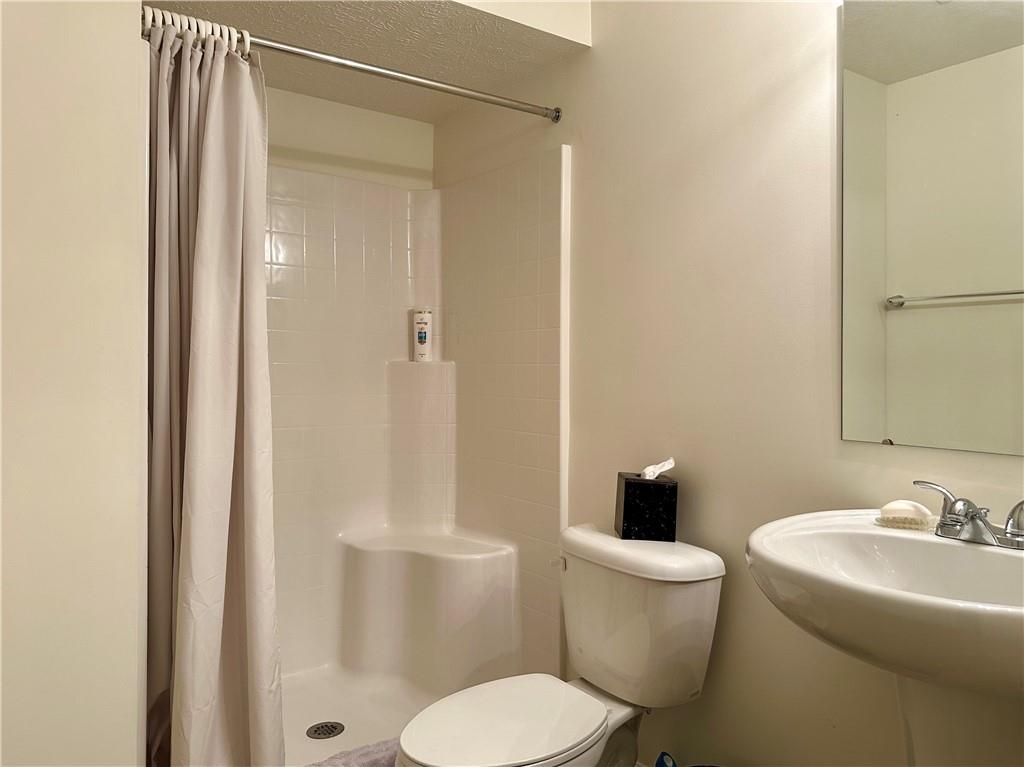 624 Setter Lane Clairton, PA 15025 - Photo 36 of 50 a white toilet sitting next to a bathroom sink