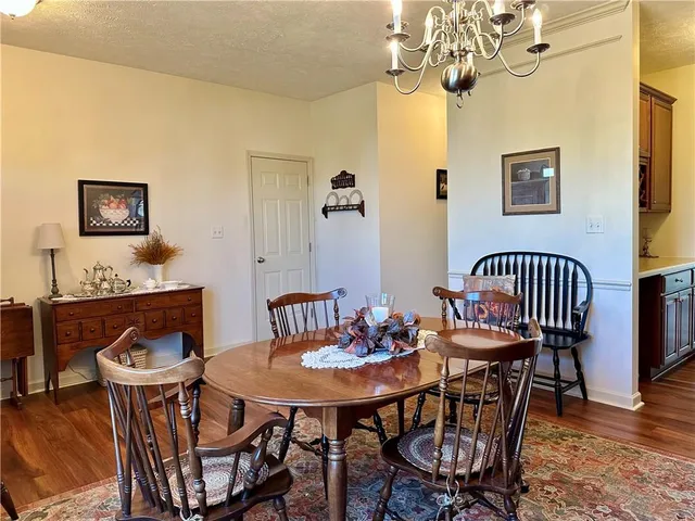 a view of a dining room with furniture and chandelier