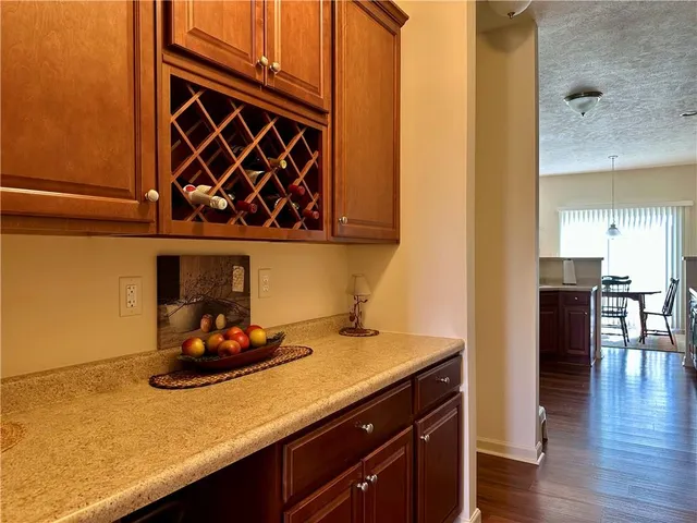 a kitchen with a sink cabinets and wooden floor