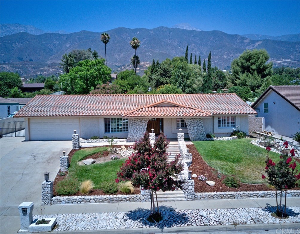 9480 Hillside Road Alta Loma, CA 91737 - Photo 1 of 1 a front view of a house with a garden