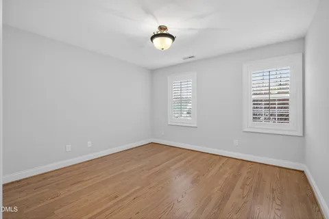 a spacious bedroom with a large bed and a window