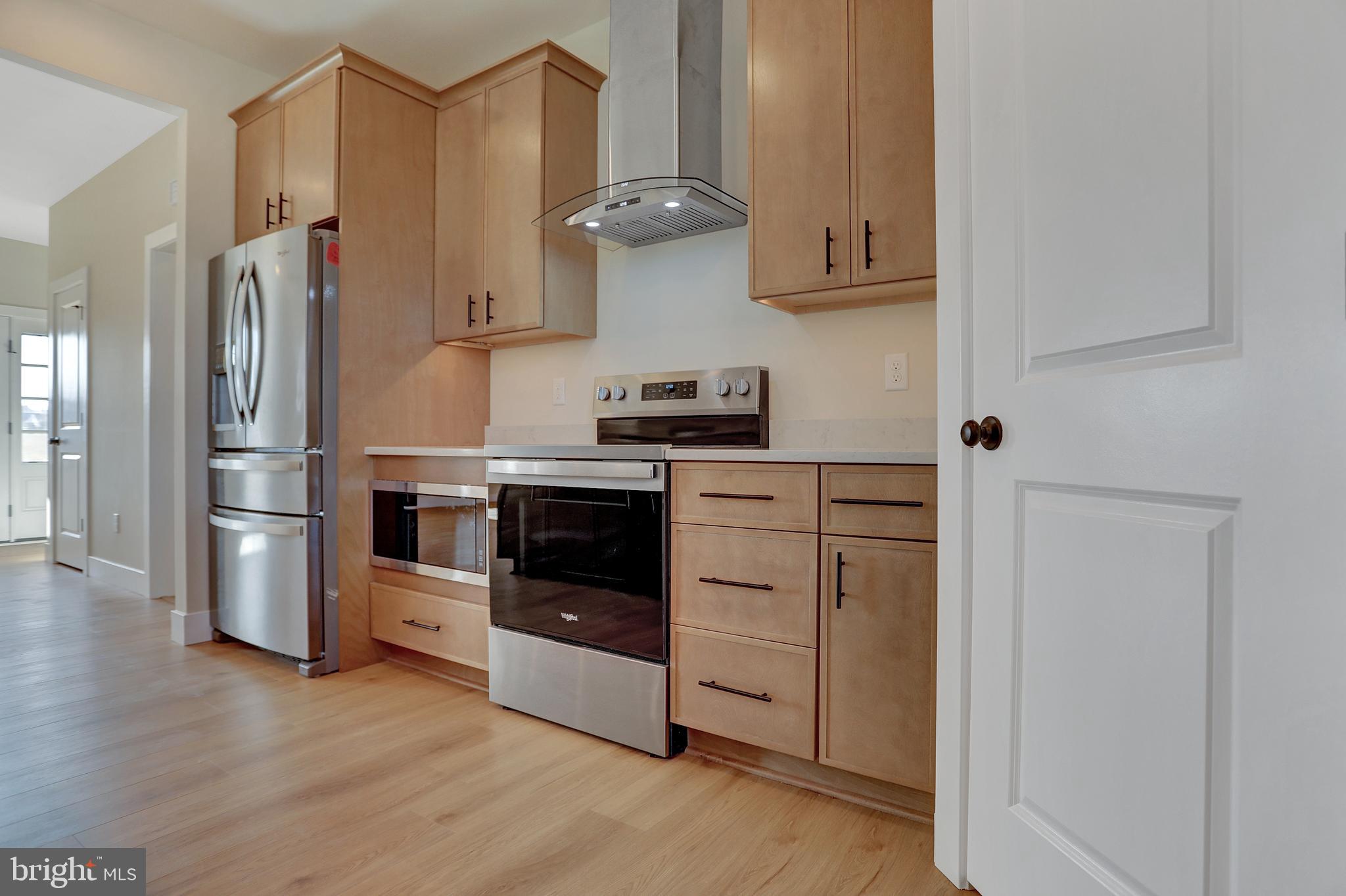 3542 Revolea Beach Road Middle River, MD 21220 - Photo 15 of 28 a kitchen with stainless steel appliances granite countertop a refrigerator stove and sink