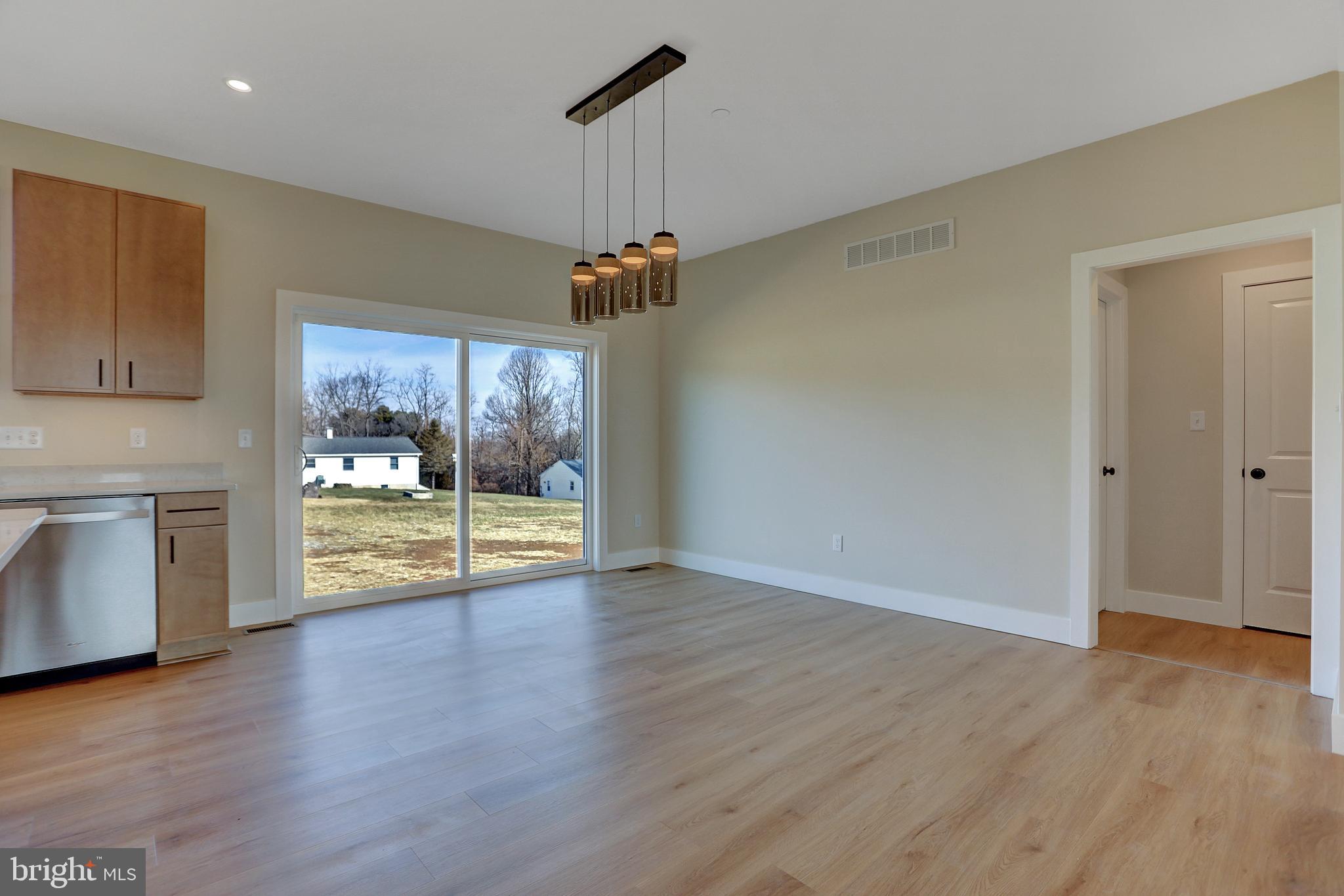 3542 Revolea Beach Road Middle River, MD 21220 - Photo 17 of 28 a view of an empty room with a window and wooden floor