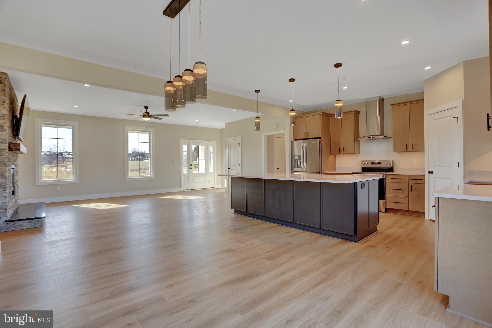 3542 Revolea Beach Road Middle River, MD 21220 - Photo 10 of 28 a view of kitchen with kitchen island wooden floor center island and stainless steel appliances
