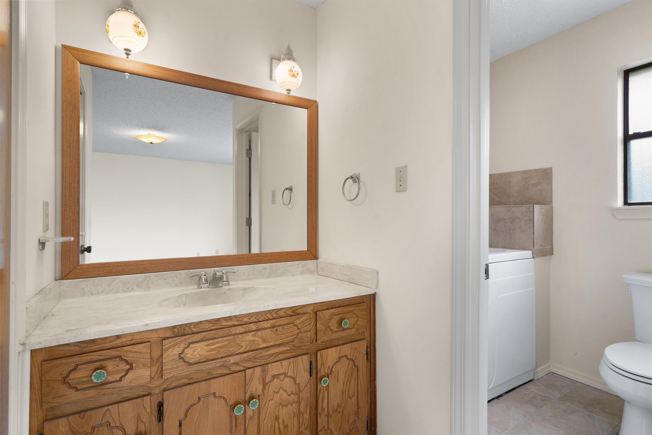 422 Patricia Road Georgetown, TX 78628 - Photo 16 of 39 a bathroom with a sink and mirror with toilet