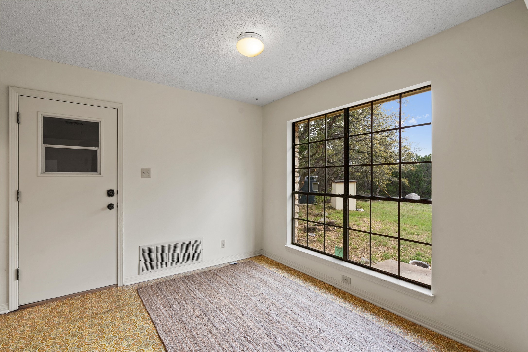 422 Patricia Road Georgetown, TX 78628 - Photo 10 of 39 a view of an empty room with wooden floor and a window