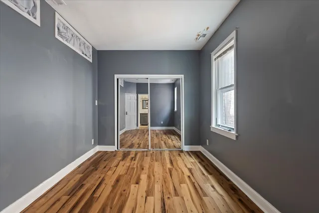 a view of a room with wooden floor and windows