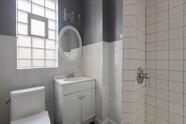 a bathroom with a sink a toilet and a mirror