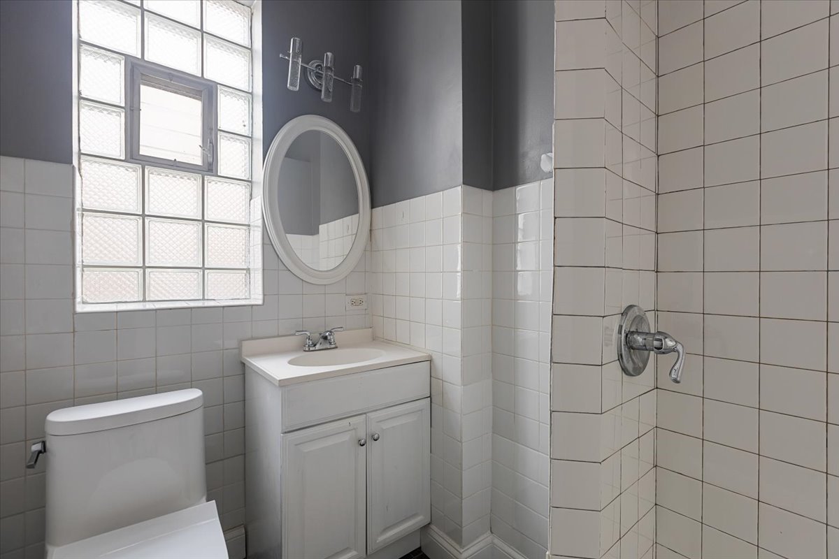 2062 North Damen Avenue Chicago, IL 60647 - Photo 14 of 26 a bathroom with a sink a toilet and a mirror