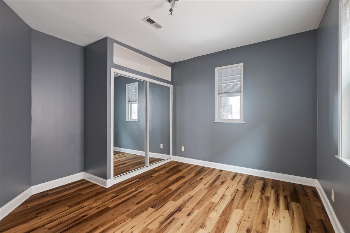2062 North Damen Avenue Chicago, IL 60647 - Photo 16 of 26 a view of an empty room with wooden floor and a window