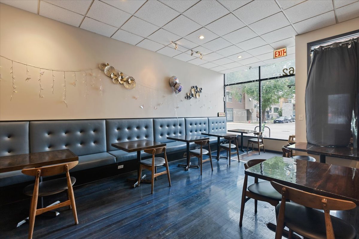 2062 North Damen Avenue Chicago, IL 60647 - Photo 21 of 26 a living room with furniture a wooden floor and next to a window