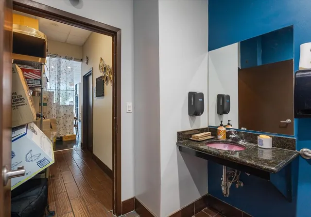 a bathroom with a sink a vanity and a mirror
