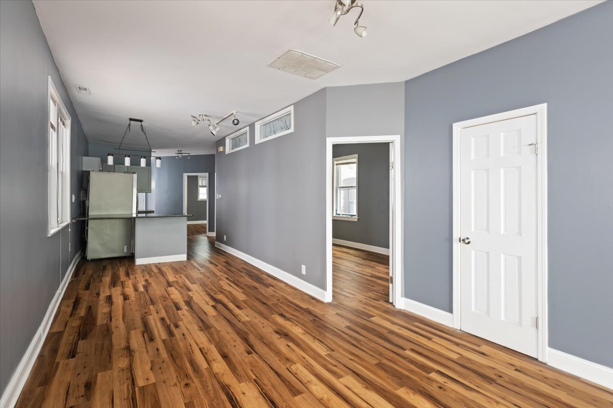 2062 North Damen Avenue Chicago, IL 60647 - Photo 7 of 26 a view of a room with wooden floor kitchen appliances and a window