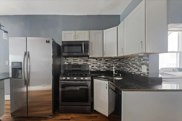 a kitchen with a refrigerator stove and sink
