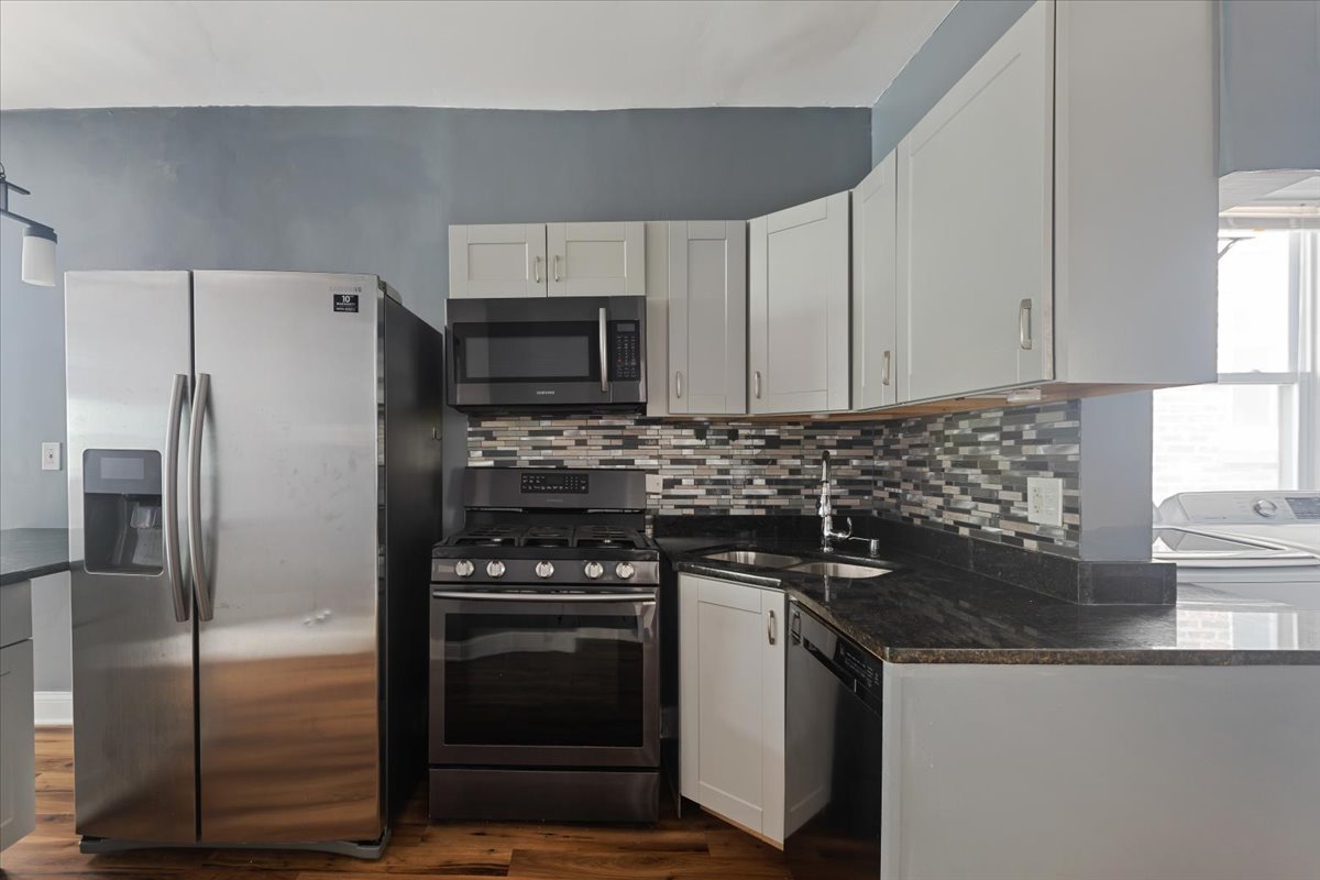 2062 North Damen Avenue Chicago, IL 60647 - Photo 8 of 26 a kitchen with a refrigerator stove and sink