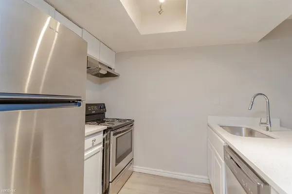 a kitchen with a sink and stainless steel appliances