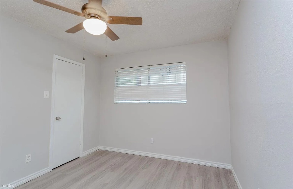 4501 Witham Lane, Unit 106 Austin, TX 78745 - Photo 7 of 11 wooden floor in an empty room with a window