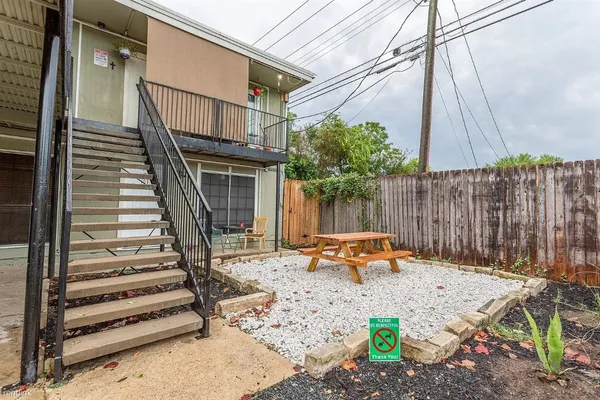 a backyard of a house with table and chairs