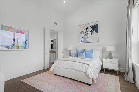 a bedroom with a bed and a painting on the wall