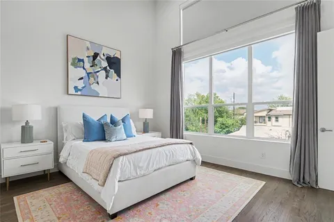 a bedroom with a large bed and a large window