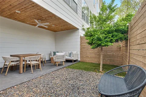 a backyard of a house with outdoor seating