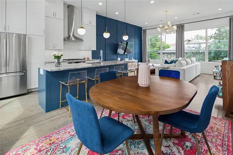 a dining room with furniture a rug and a chandelier