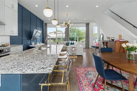 a large kitchen with kitchen island a large window in it