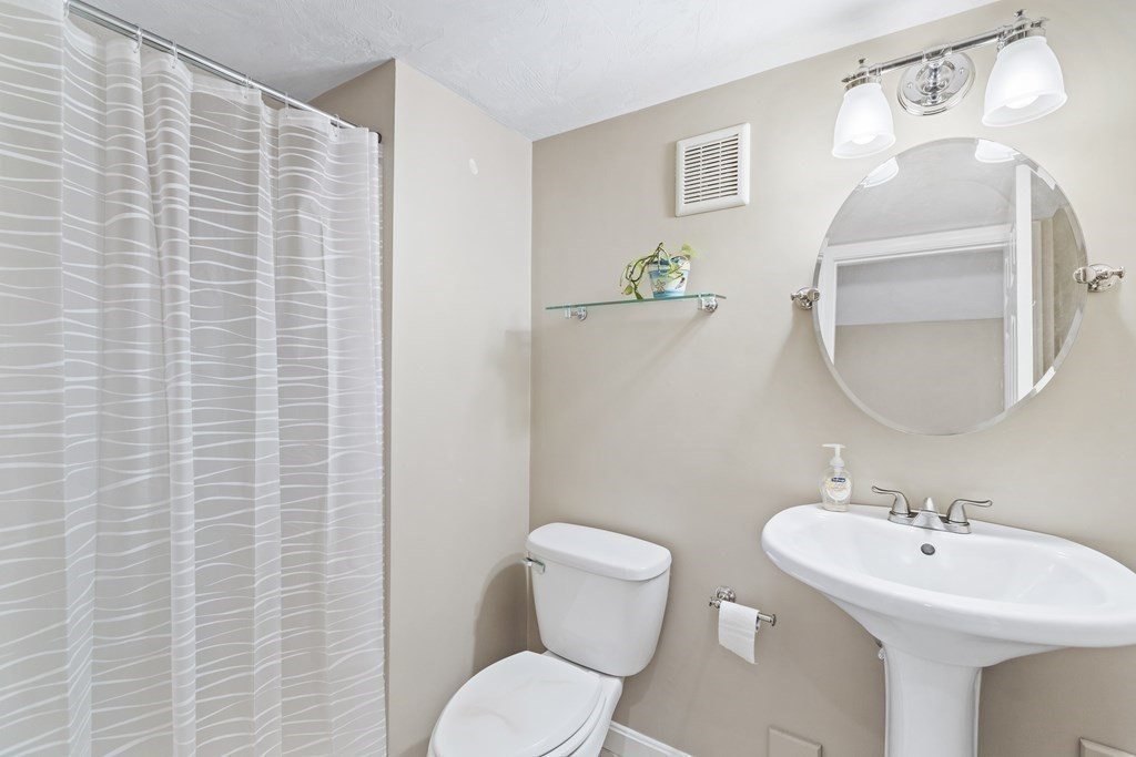 21 Honeysuckle Road Worcester, MA 01607 - Photo 30 of 38 a bathroom with a toilet sink and mirror
