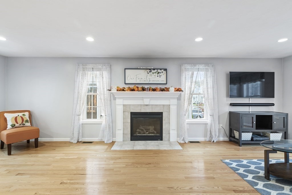 21 Honeysuckle Road Worcester, MA 01607 - Photo 10 of 38 a living room with furniture a fireplace and a flat screen tv
