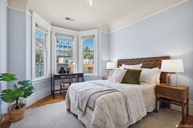 a bedroom with a bed and a table