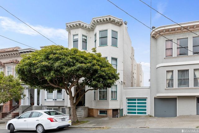 a front view of a residential apartment building with a yard