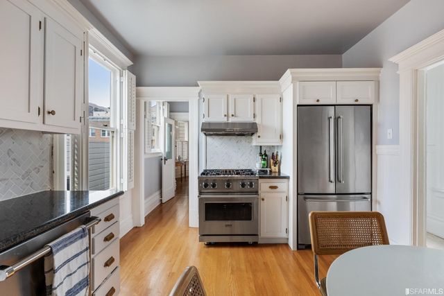 a kitchen with stainless steel appliances a refrigerator sink and microwave
