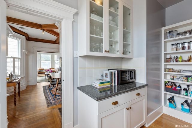 a kitchen with a cabinets and wooden floor
