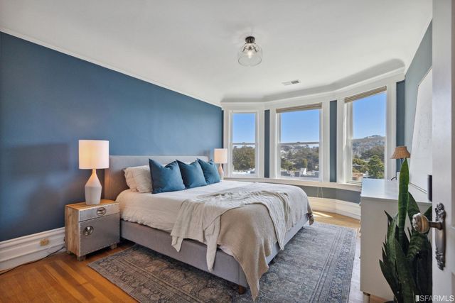 a bedroom with a large bed and a large window