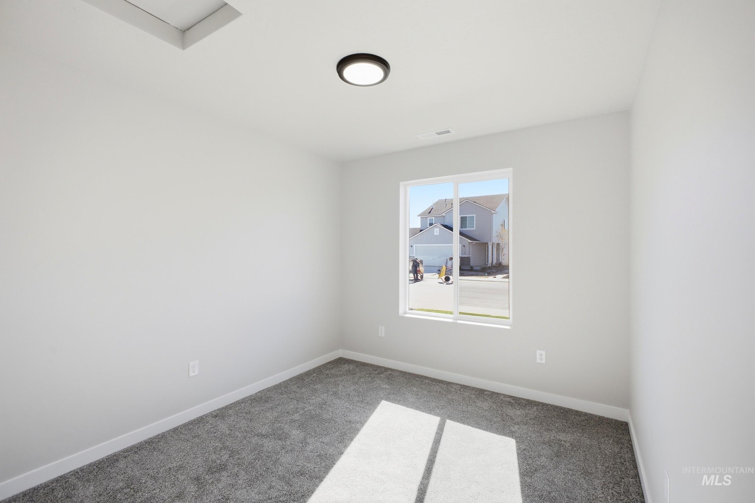 13325 Scrape Street Caldwell, ID 83607 - Photo 10 of 24 Wall-to-wall carpeting and a ceiling-mounted light fixture