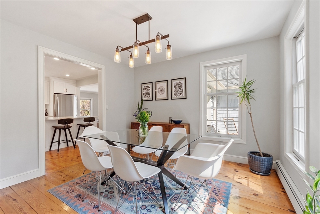 4 Willow Road Harvard, MA 01451 - Photo 15 of 42 a dining room with wooden floor and a chandelier