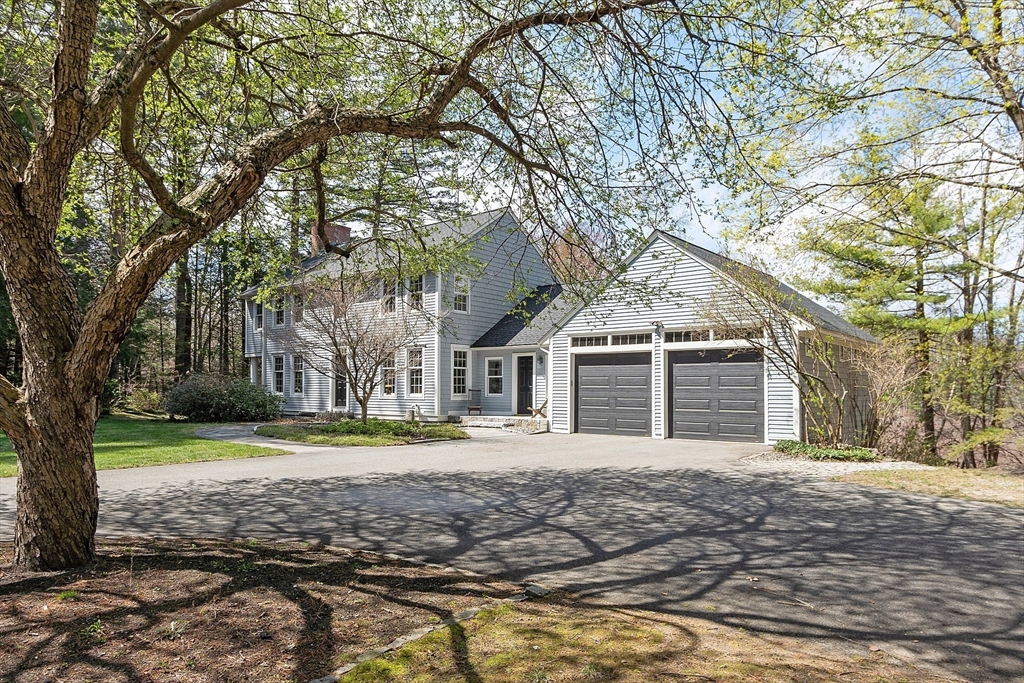 4 Willow Road Harvard, MA 01451 - Photo 2 of 42 a front view of a house with a yard and garage
