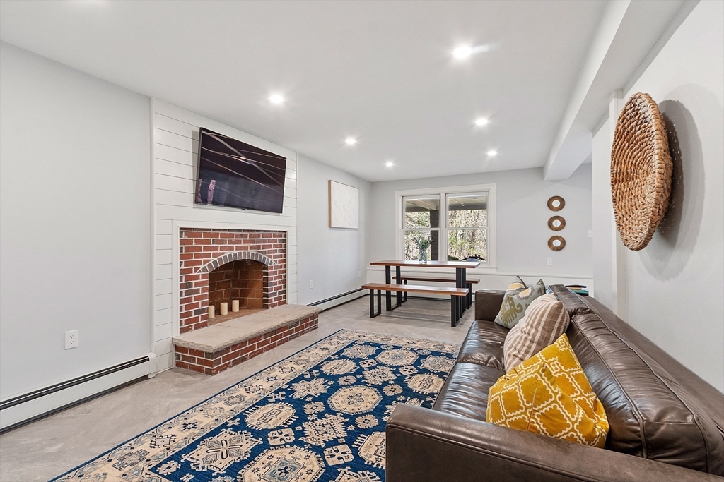 4 Willow Road Harvard, MA 01451 - Photo 29 of 42 a living room with furniture and a fireplace