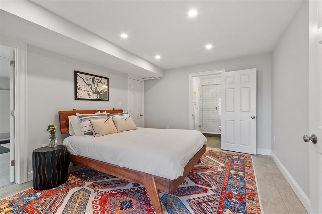 4 Willow Road Harvard, MA 01451 - Photo 32 of 42 a bed room with a bed and a lamp