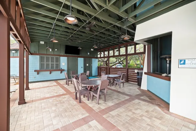 a view of a porch with table and chairs
