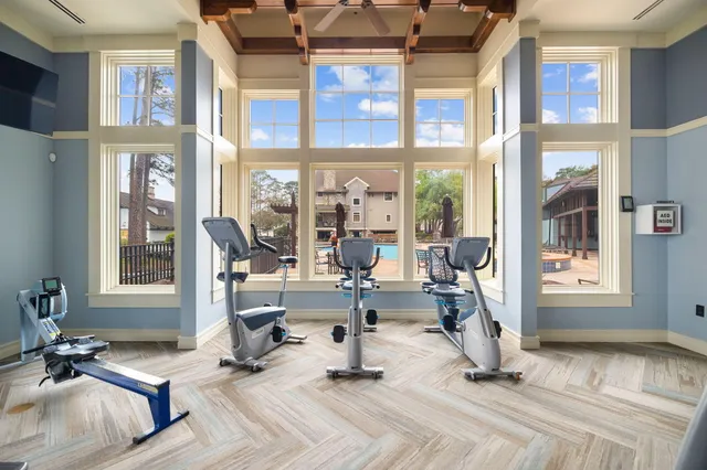 a view of a livingroom with couch and large windows