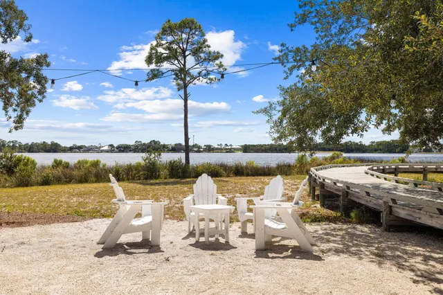 a view of a lake with lawn chairs