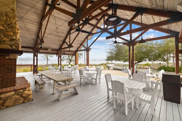 a view of a patio with table and chairs and wooden floor