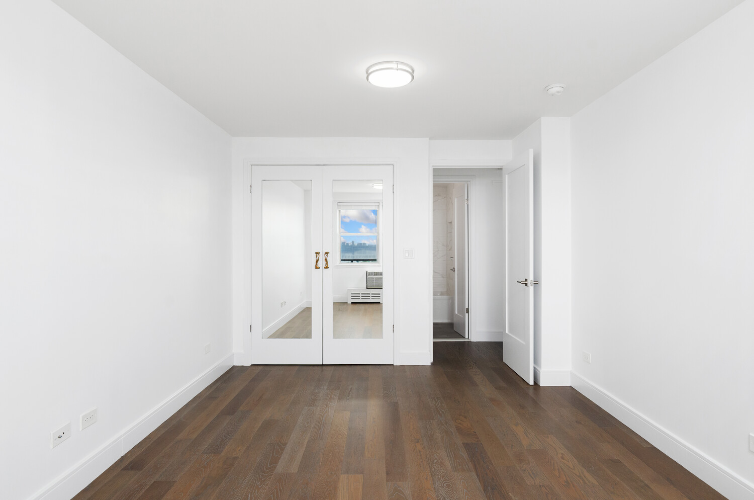 5700 Arlington Avenue, Unit 12T Bronx, NY 10471 - Photo 15 of 39 a view of wooden floor and windows in a room