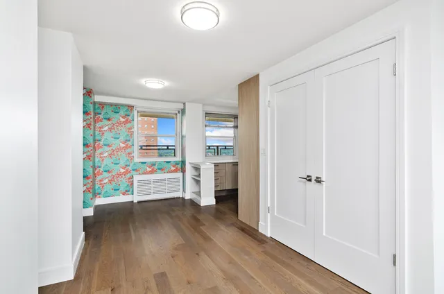 a view of an entryway with wooden floor