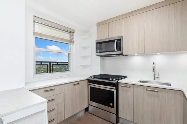 a kitchen with cabinets stainless steel appliances and a sink
