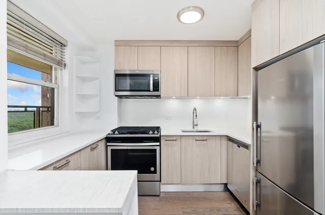 a kitchen with a refrigerator sink and microwave