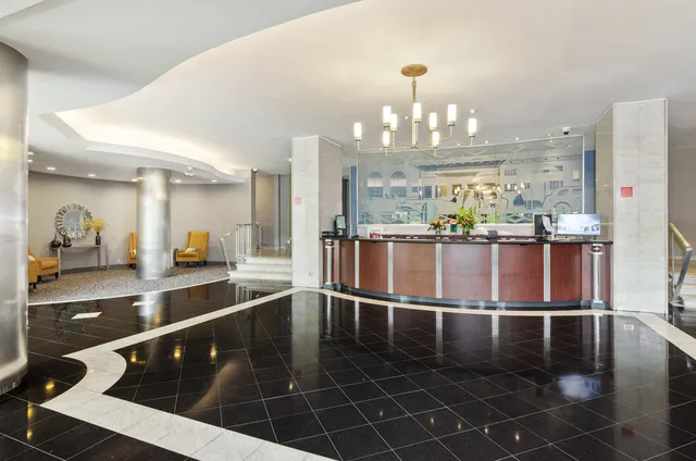 a kitchen with stainless steel appliances a dining table chairs and granite counter tops